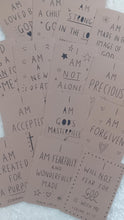 Load image into Gallery viewer, Brown paper with motivational text phrases printed on it.