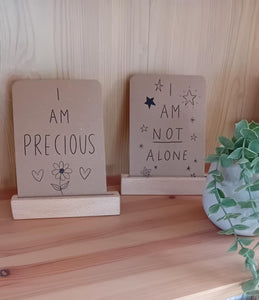 Wooden shelves with motivational signs and books on a wooden surface