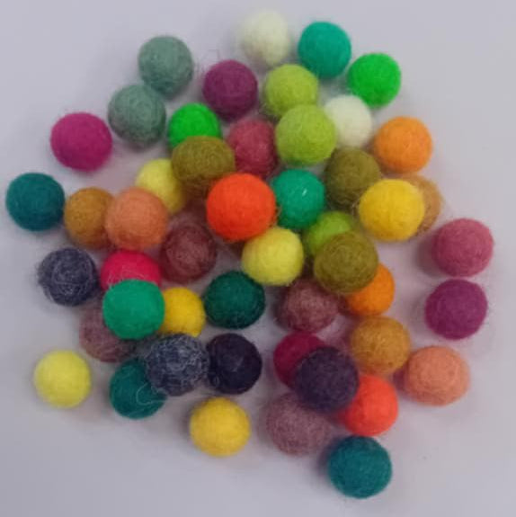 Colorful felt balls on a white background