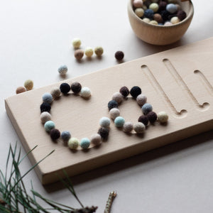 Wooden name board with felt balls